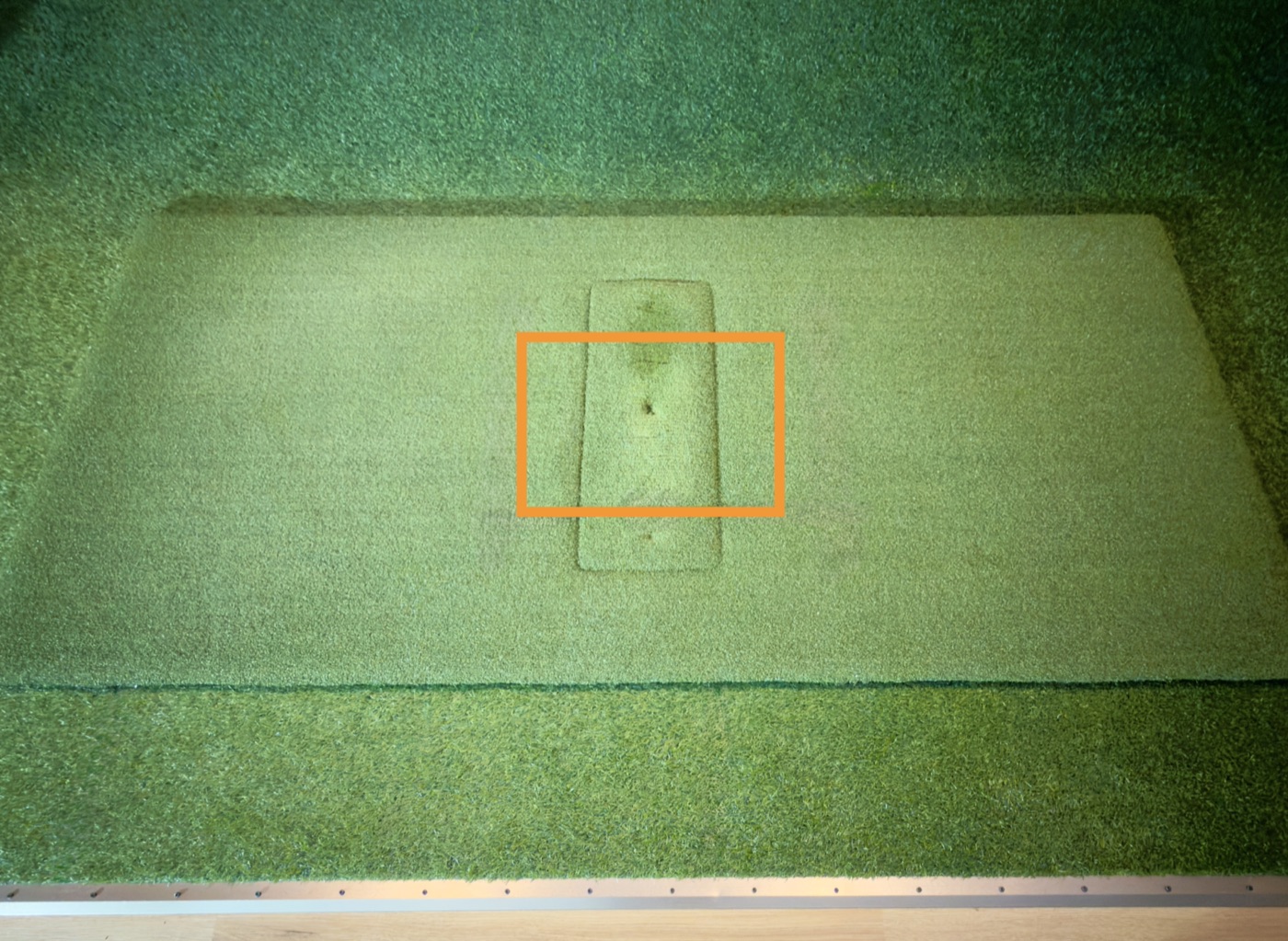Overhead view of the mat with the hitting area outlined in orange